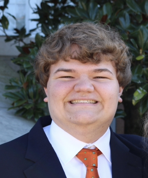 A child in a suit and tie  AI-generated content may be incorrect.